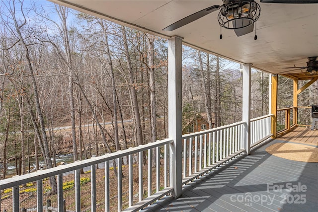 wooden terrace with a ceiling fan