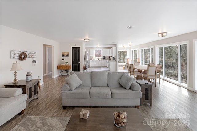 living room featuring light wood-style floors and baseboards