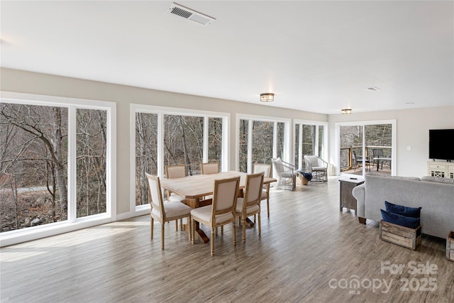 dining space featuring visible vents and wood finished floors