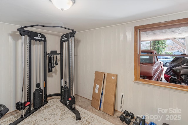 workout room featuring wooden walls