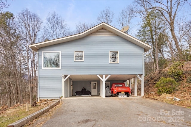 view of front of property with a carport and aphalt driveway