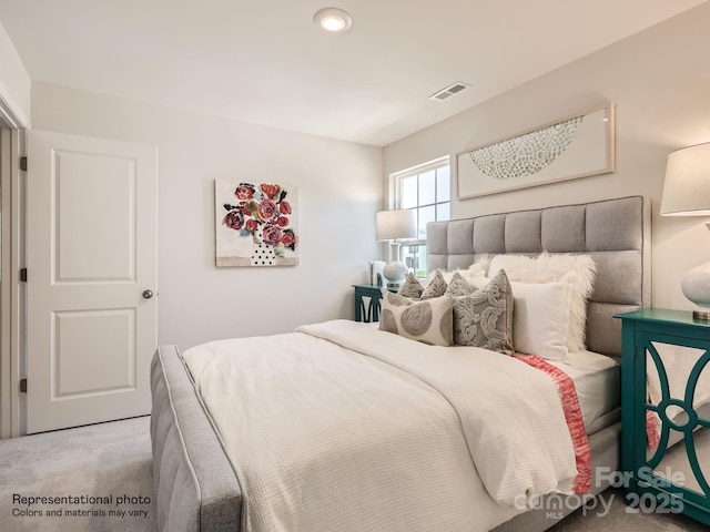 carpeted bedroom featuring visible vents