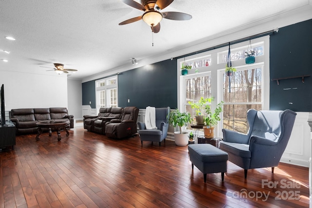 living area featuring hardwood / wood-style floors, a textured ceiling, plenty of natural light, and ceiling fan