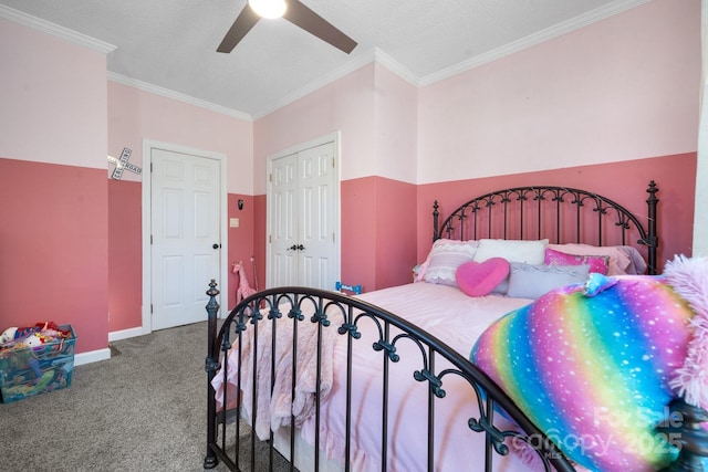 carpeted bedroom with baseboards, ceiling fan, a closet, a textured ceiling, and crown molding