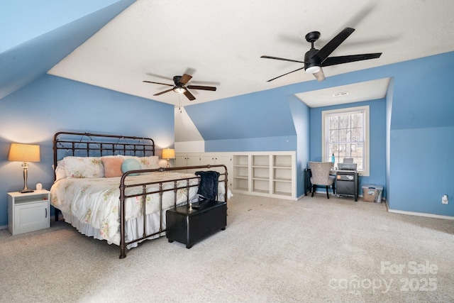 carpeted bedroom with vaulted ceiling, baseboards, and ceiling fan