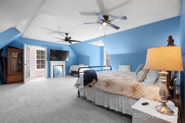 bedroom featuring a ceiling fan, vaulted ceiling, carpet, and a textured ceiling