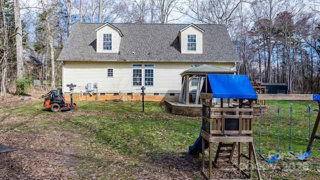 back of property featuring a playground, roof with shingles, a gazebo, a lawn, and crawl space