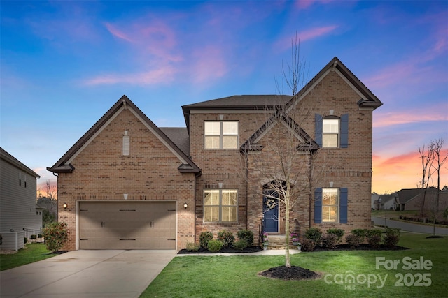 traditional-style house featuring brick siding, concrete driveway, and a front lawn