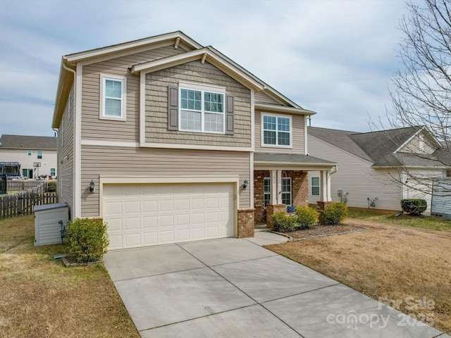 craftsman inspired home featuring brick siding, a front lawn, fence, concrete driveway, and an attached garage