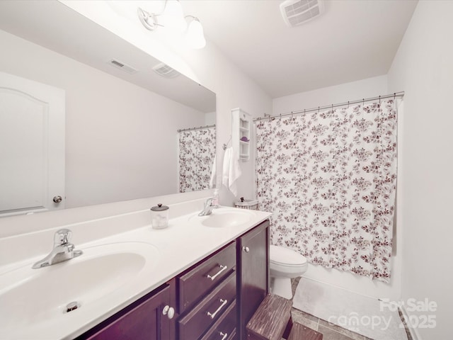 full bath with double vanity, visible vents, and a sink