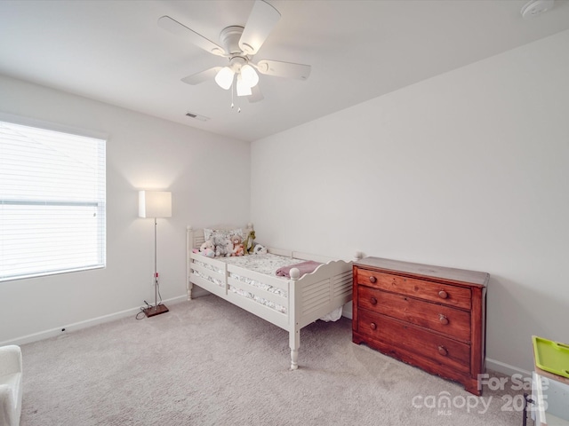 bedroom with visible vents, baseboards, a ceiling fan, and carpet flooring