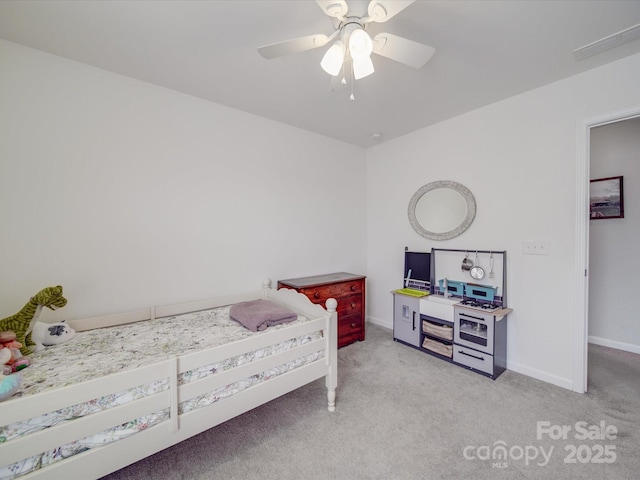 bedroom featuring visible vents, light colored carpet, baseboards, and ceiling fan