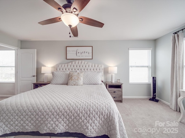 bedroom featuring ceiling fan, baseboards, and light carpet