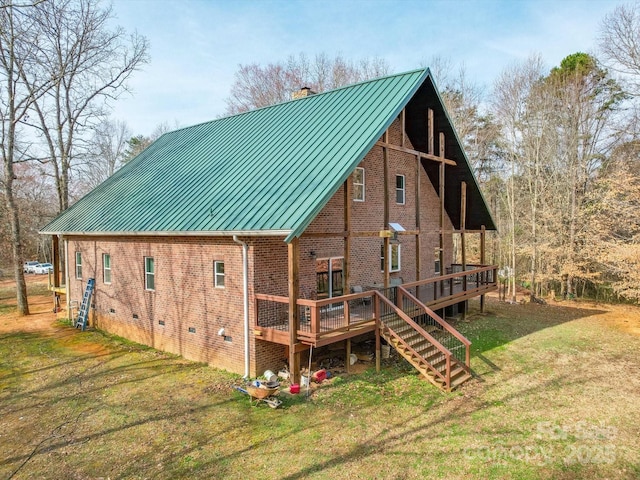 rear view of house with a chimney, metal roof, and a standing seam roof