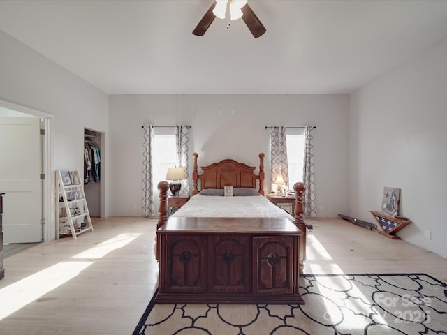 bedroom with light wood-style flooring and a ceiling fan