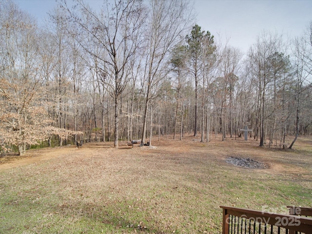 view of yard featuring a forest view