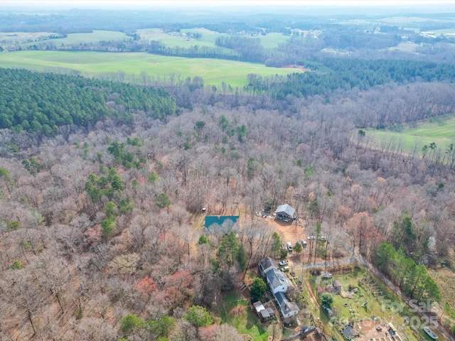 bird's eye view with a wooded view