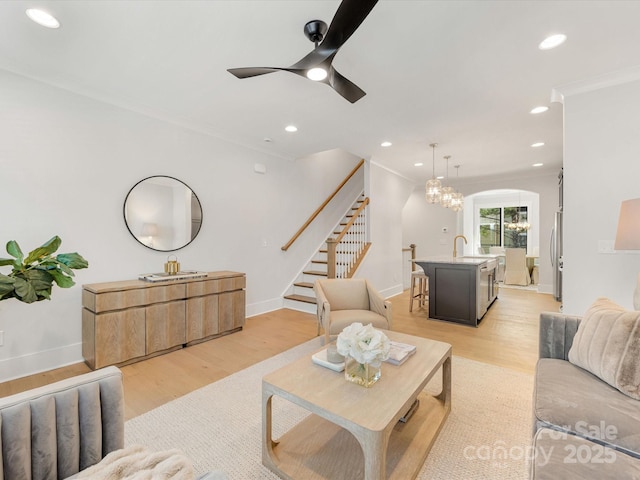 1409 Kenilworth Ave, Charlotte, NC 28203 - living area with light wood finished floors, a ceiling fan, arched walkways, crown molding, and recessed lighting