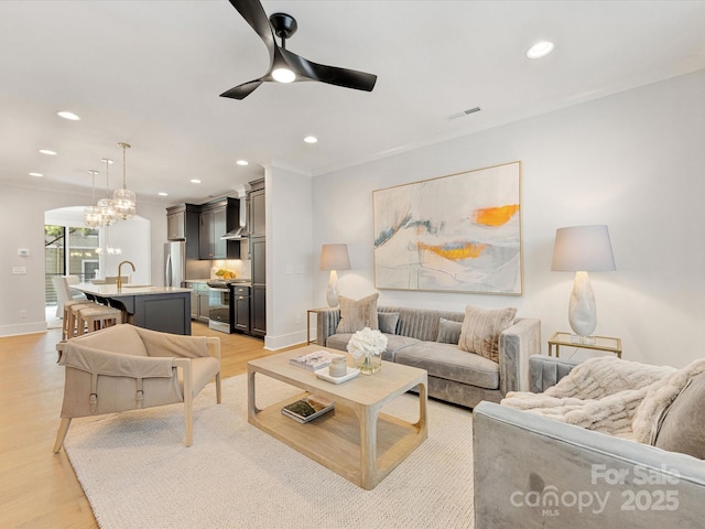 1409 Kenilworth Ave, Charlotte, NC 28203 - living room featuring a ceiling fan, light wood finished floors, recessed lighting, and a chandelier