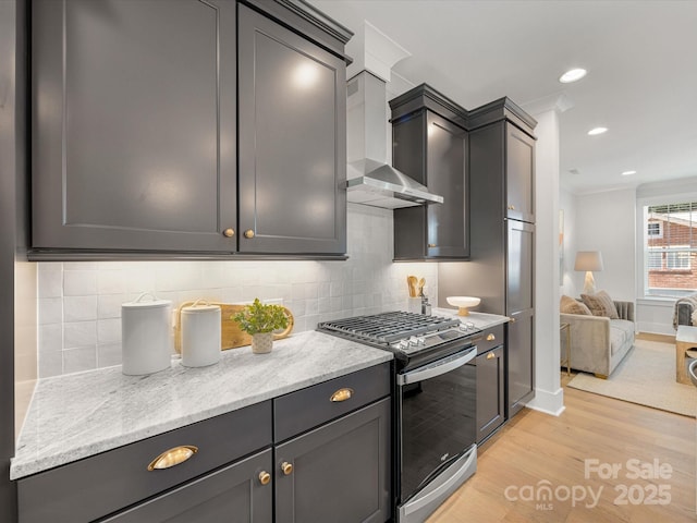 1409 Kenilworth Ave, Charlotte, NC 28203 - kitchen featuring gas stove, wall chimney range hood, light wood-style flooring, backsplash, and light stone counters