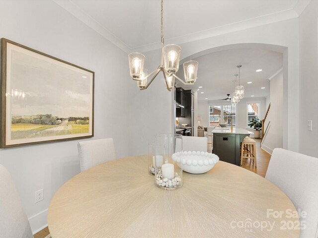 1409 Kenilworth Ave, Charlotte, NC 28203 - dining area featuring a chandelier, recessed lighting, wood finished floors, ornamental molding, and ceiling fan