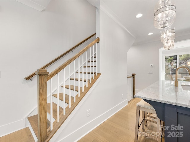 1409 Kenilworth Ave, Charlotte, NC 28203 - stairway featuring wood finished floors, recessed lighting, and ornamental molding