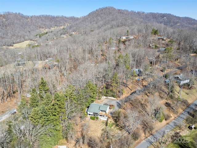 drone / aerial view with a mountain view and a forest view