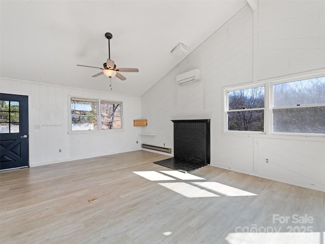 unfurnished living room featuring a ceiling fan, an AC wall unit, a brick fireplace, light wood-type flooring, and baseboard heating