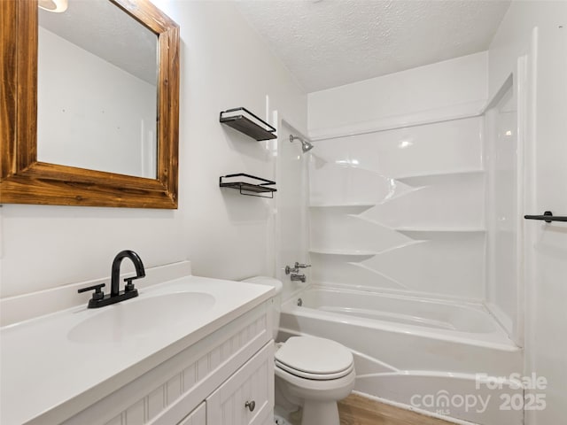 full bathroom featuring vanity, a textured ceiling, bathing tub / shower combination, and toilet