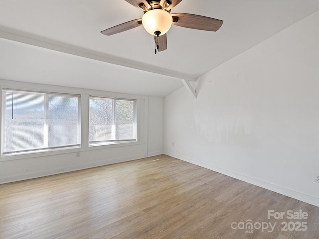 spare room with ceiling fan, baseboards, and light wood-style floors