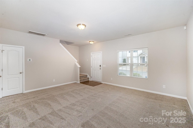 interior space featuring visible vents, carpet floors, baseboards, and stairs