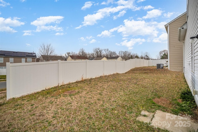 view of yard with cooling unit and fence