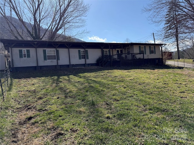 exterior space featuring a lawn and fence