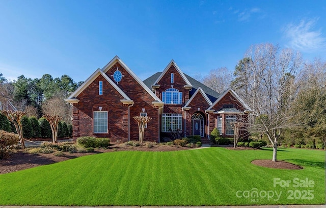 craftsman-style house with a front yard and brick siding