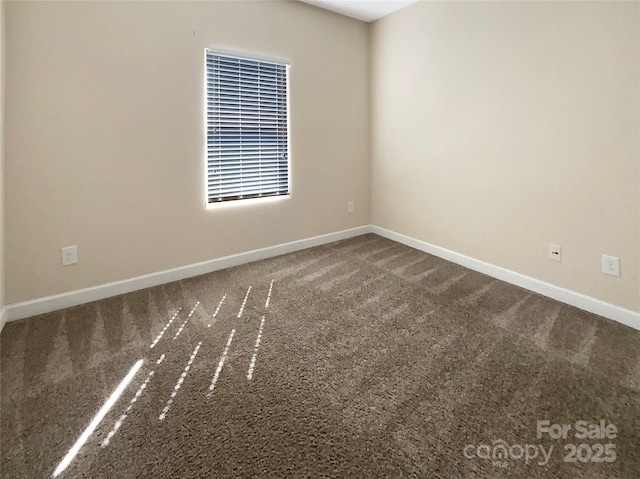 empty room with baseboards and carpet floors