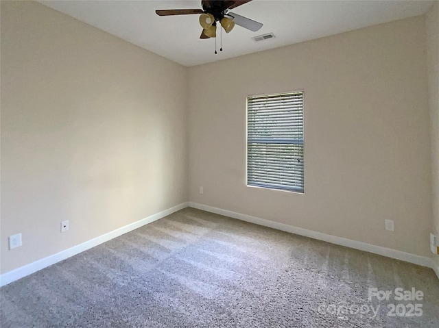 unfurnished room with visible vents, baseboards, carpet, and ceiling fan