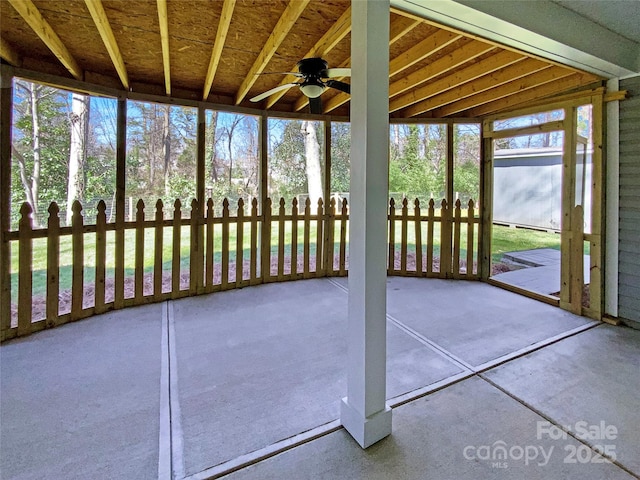 unfurnished sunroom with ceiling fan