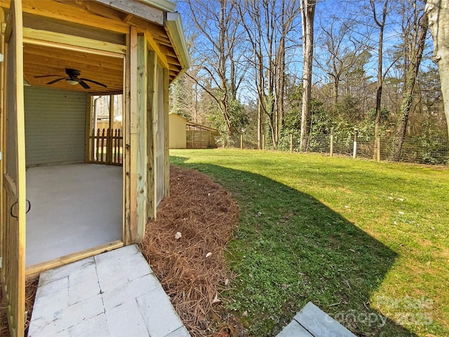 view of yard featuring ceiling fan, a patio, and a fenced backyard