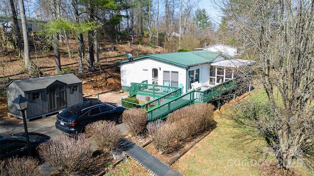 view of front of property with a storage shed and an outbuilding