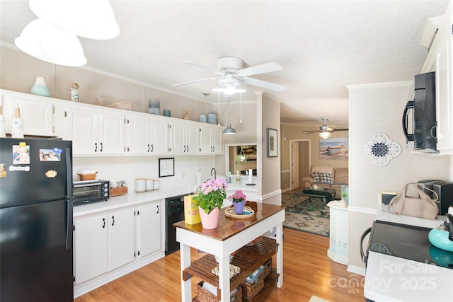 kitchen with light wood-style floors, black appliances, ceiling fan, and white cabinets