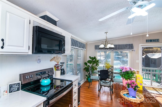 kitchen with light wood-style flooring, black appliances, white cabinets, light countertops, and ceiling fan with notable chandelier