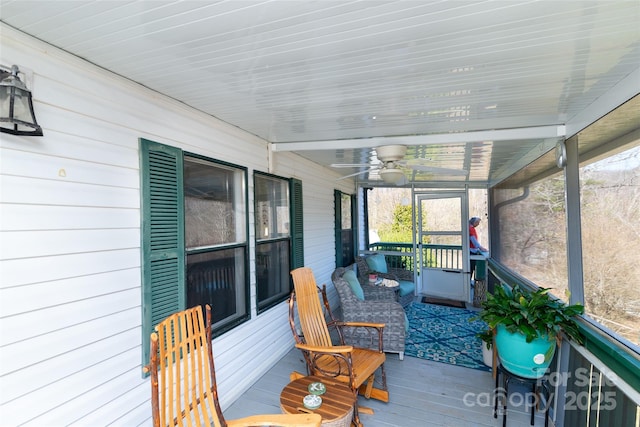 sunroom featuring ceiling fan