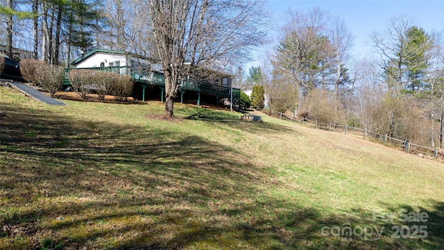 view of yard with a wooden deck and fence