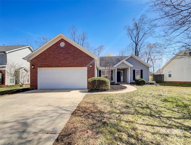 view of front of property featuring driveway, fence, a front yard, a garage, and brick siding