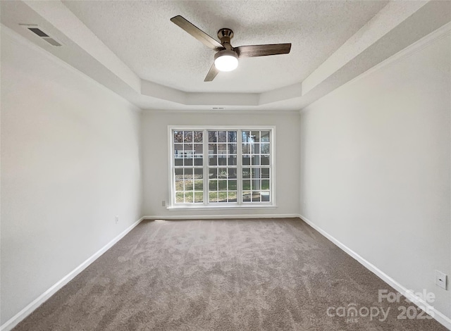 carpeted spare room with baseboards, visible vents, a textured ceiling, and ceiling fan