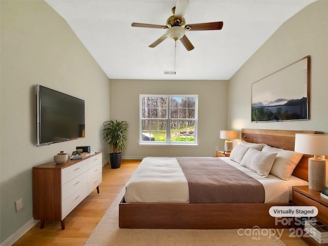 bedroom featuring a ceiling fan, visible vents, light wood finished floors, and baseboards