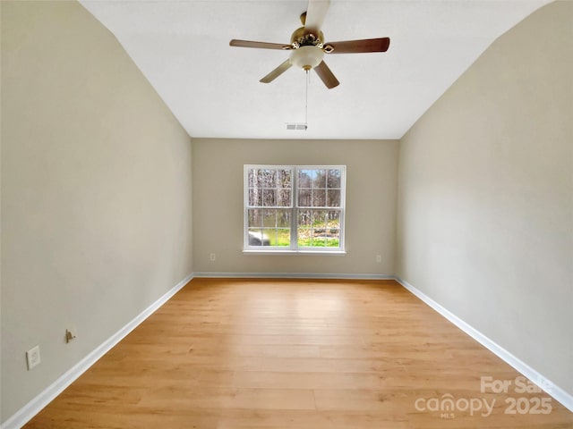 unfurnished room with baseboards, visible vents, a ceiling fan, and light wood-style floors