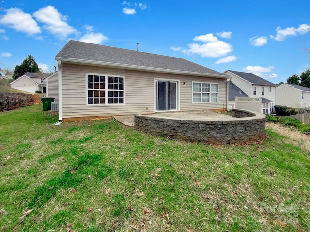 back of house with a patio, a lawn, fence, and roof with shingles