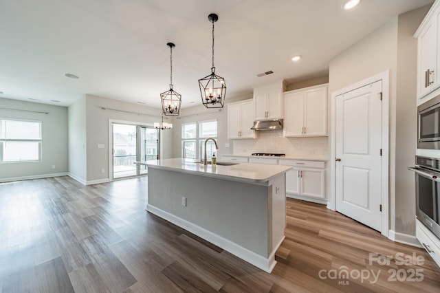 1819 Lotus Ln, Denver, NC 28037 - kitchen with a sink, appliances with stainless steel finishes, a chandelier, an island with sink, and light countertops