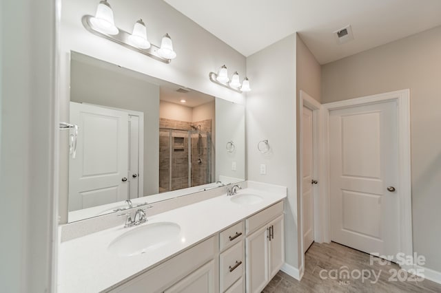1819 Lotus Ln, Denver, NC 28037 - bathroom featuring double vanity, a stall shower, baseboards, and wood finished floors